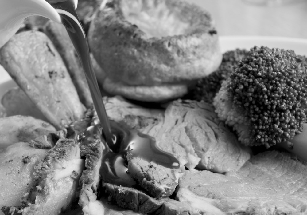 Gravy being Poured on a plate of Roast Beef