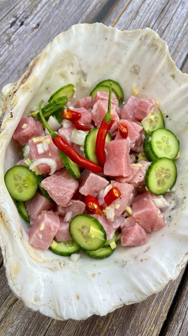 A bowl of finished tuna kinilaw with cucumber rounds