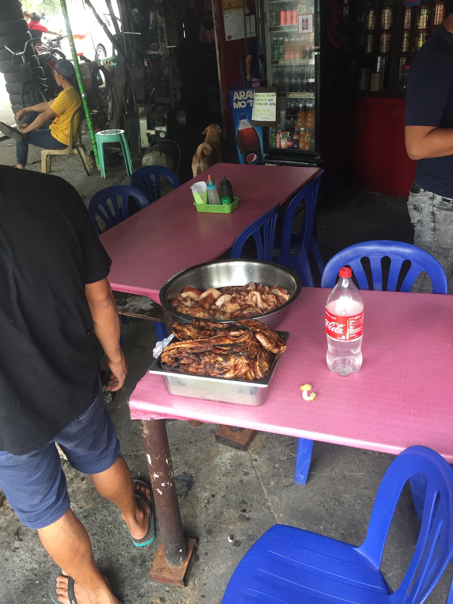 Trays of grilled liempo and pork on the table at Sosing's Carinderia